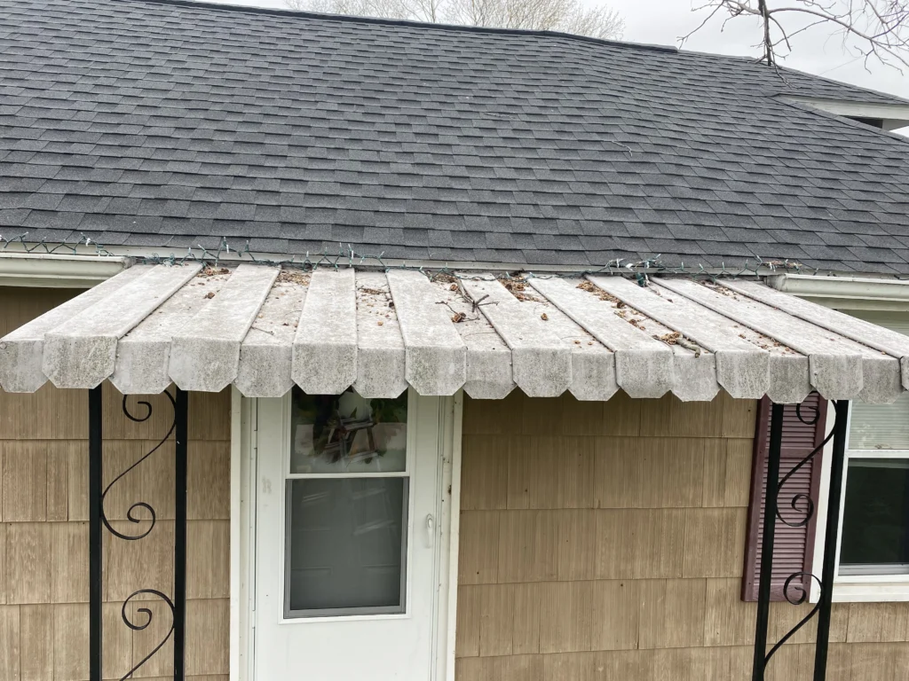 Dirty awning covered in green growth